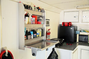 Special wall racks and securely mounted refrigerator and microwave keep trailers organized and safe.